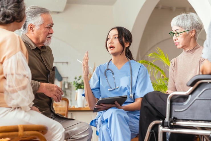 Caregiver talking with a group of seniors