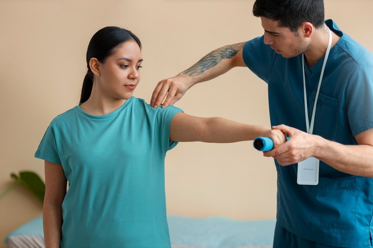 Therapist guiding a shoulder exercise